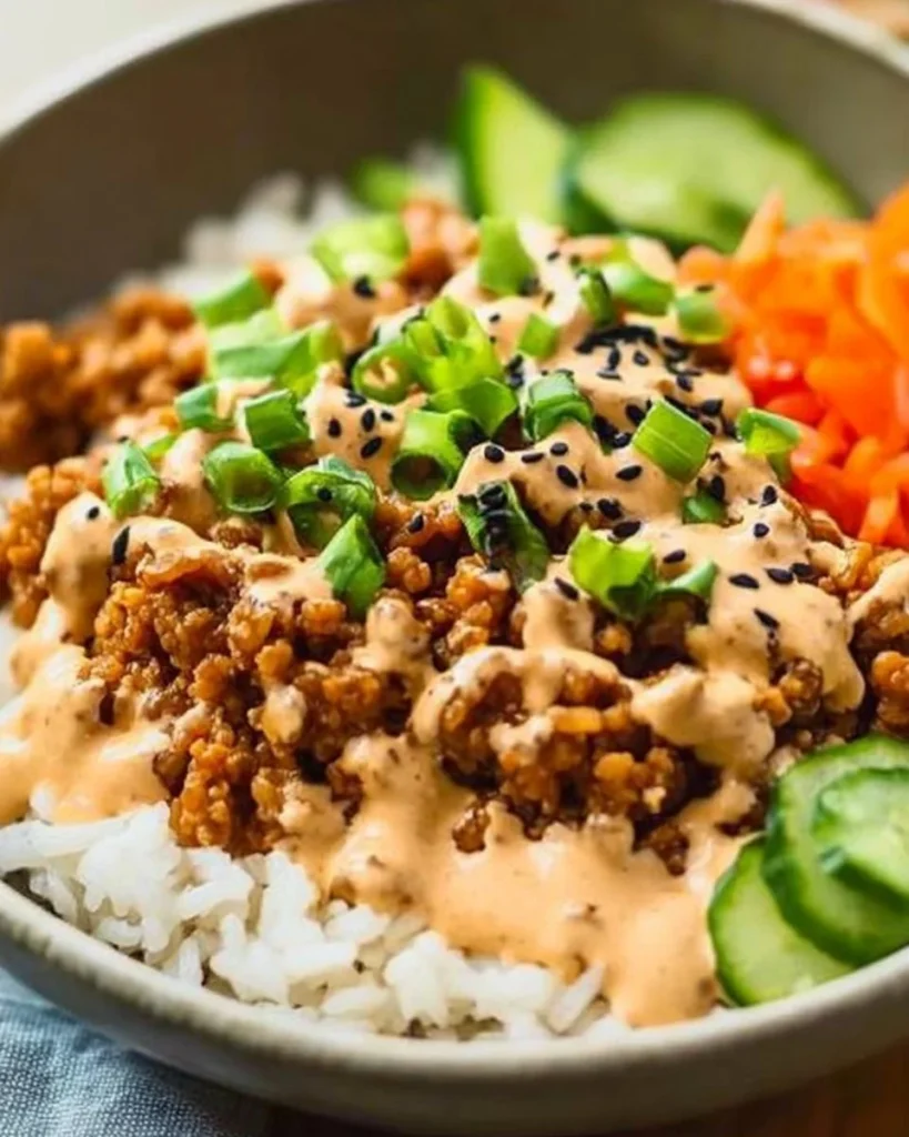 Ground turkey rice bowls topped with bang bang sauce for a flavorful meal