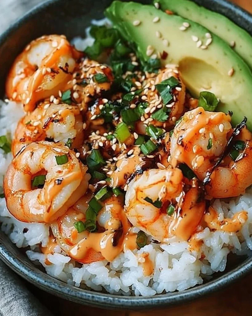 Shrimp rice bowls topped with spicy mayo, garnished with vegetables
