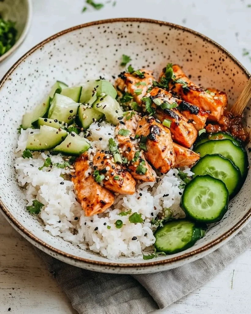 Delicious spicy salmon bowls served with creamy coconut rice for a flavorful dish