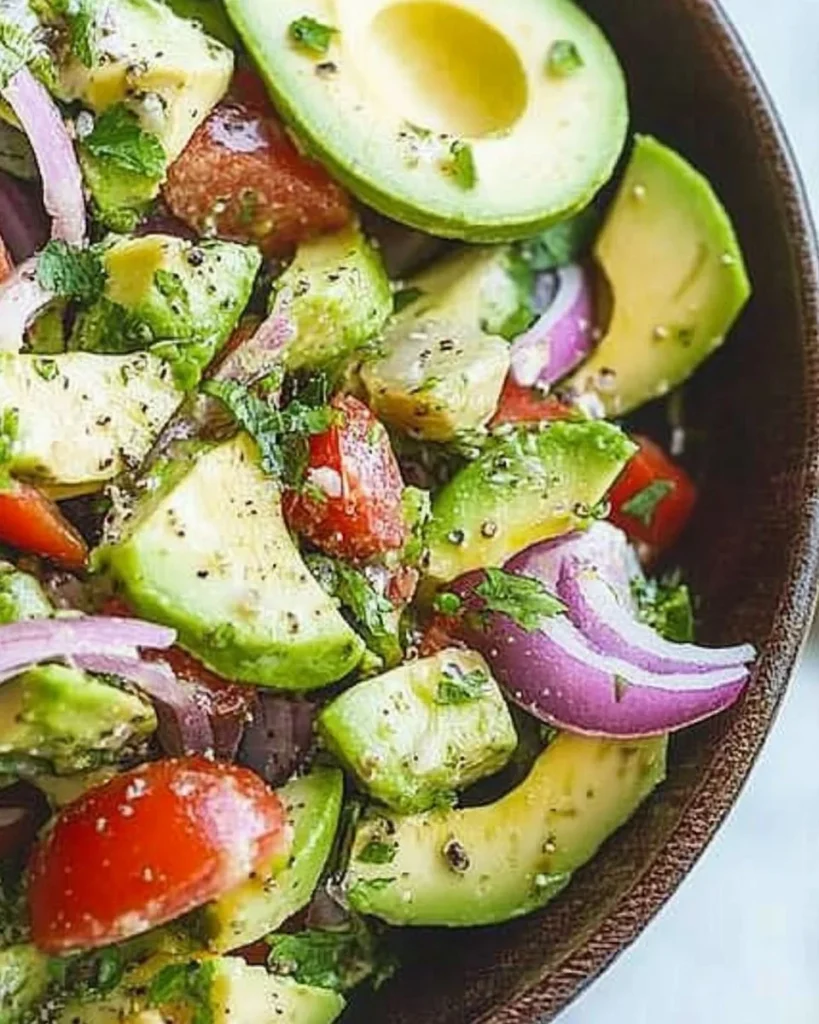 Fresh avocado salad with greens and colorful vegetables