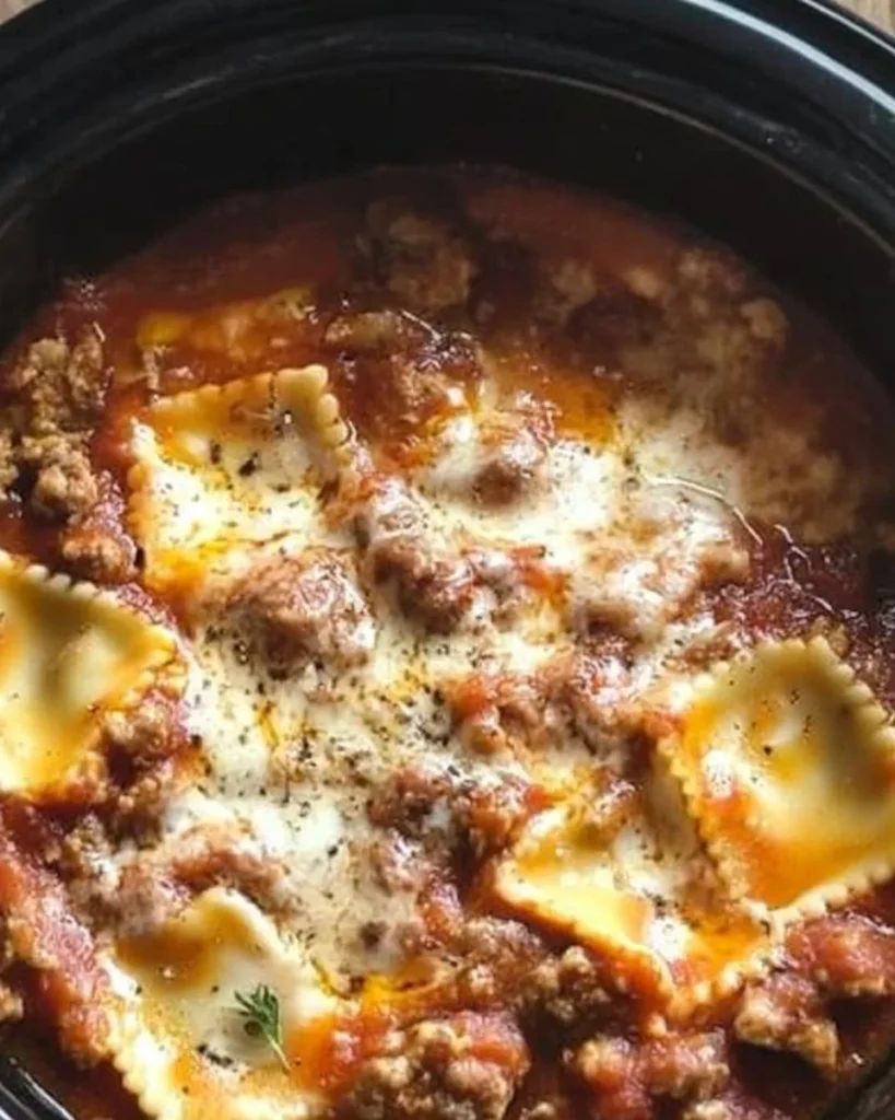 Delicious crockpot ravioli lasagna served in a bowl with melted cheese on top