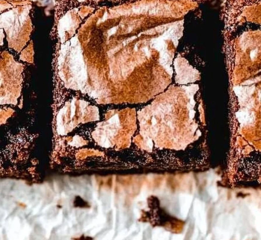 Deliciously fudgy sourdough brownies served on a rustic wooden table