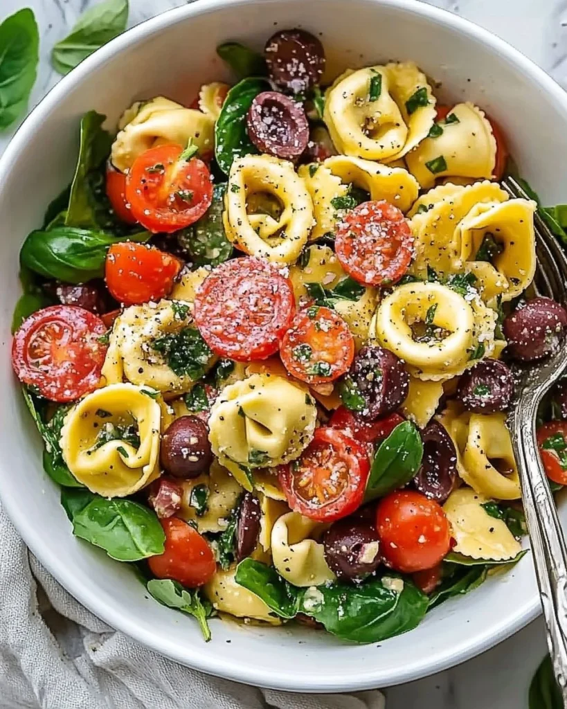 Colorful Tortellini Pasta Salad with vegetables and dressing in a bowl